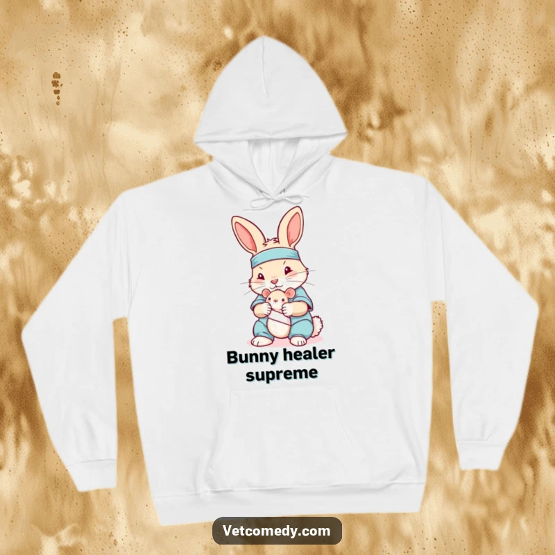 Funny hoodie featuring a rabbit in medical scrubs, tenderly bandaging a stuffed mouse, offering warmth and humor.